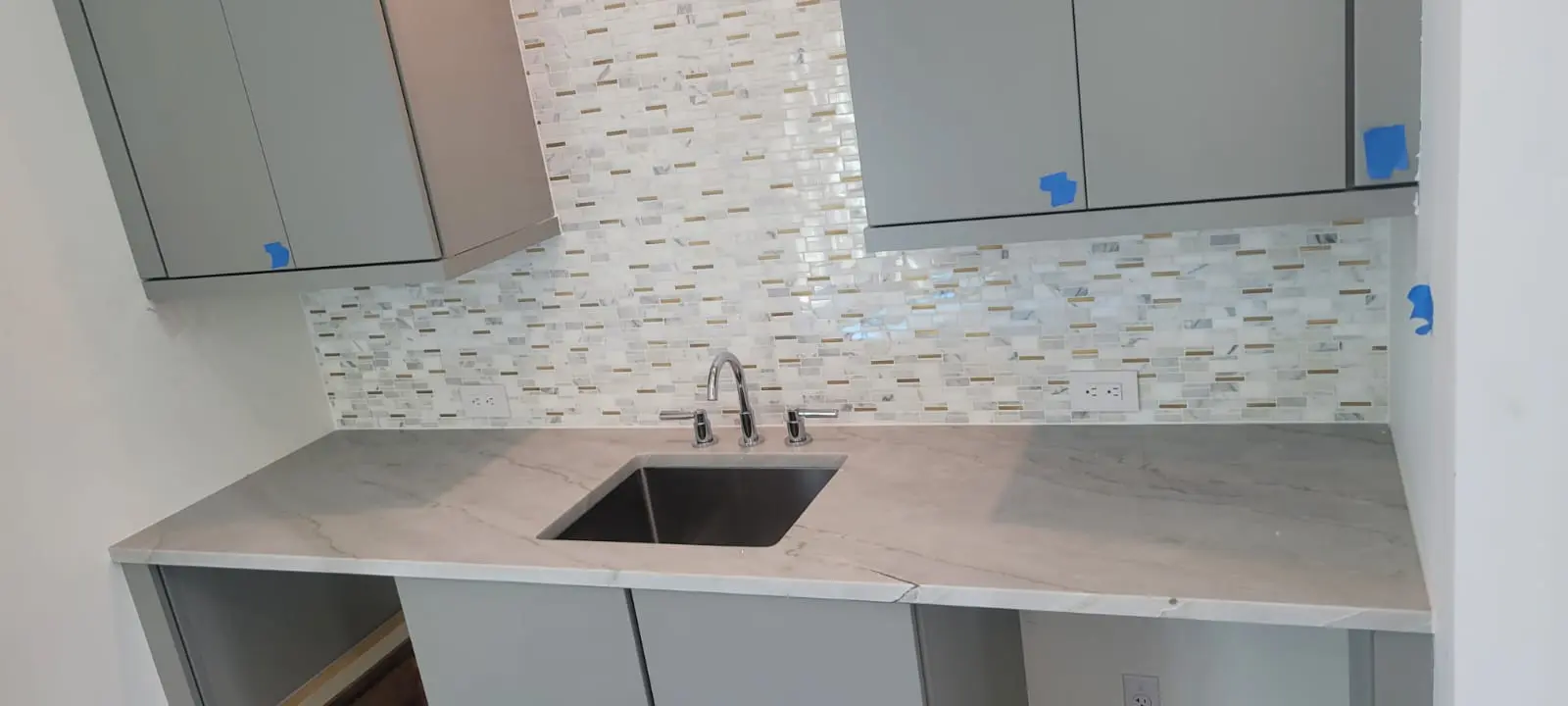 A kitchen with a sink and cabinets in it
