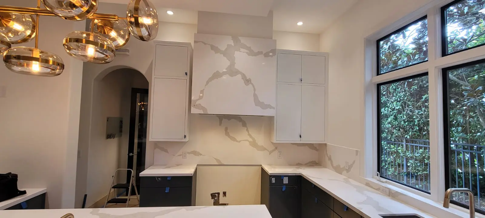 A kitchen with marble walls and counters